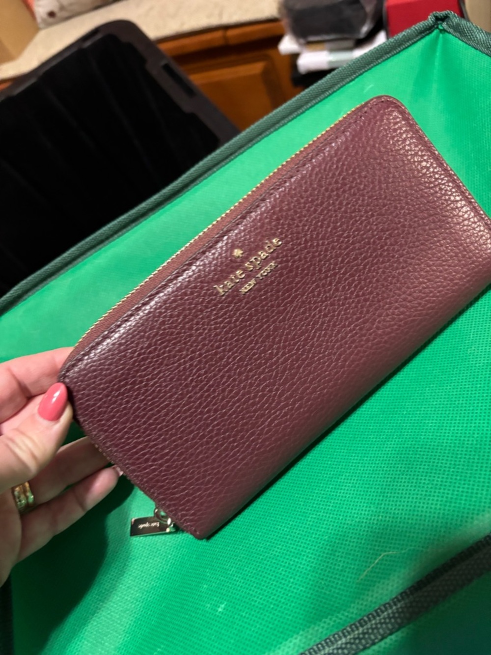 kate spade pebbled leather zip wallet in wine with gold logo
